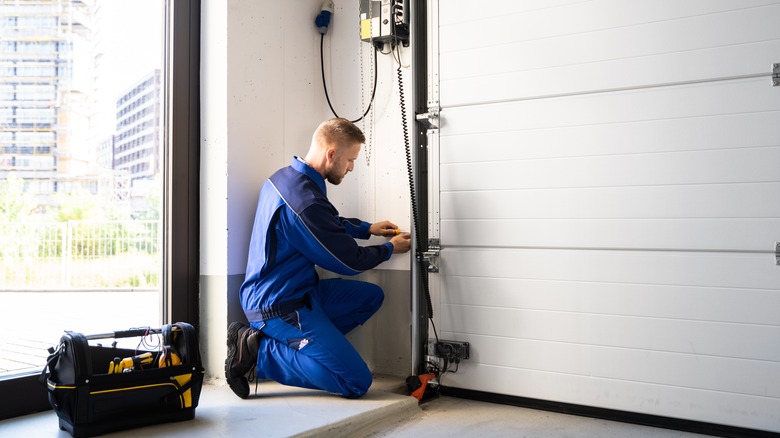 Man repairing automatic garage door