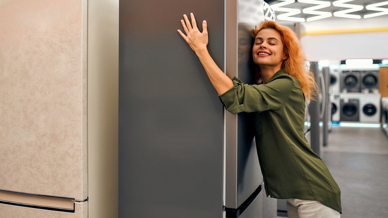 woman hugging refrigerator