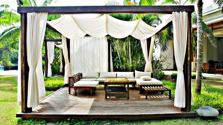 wood pergola with white curtains