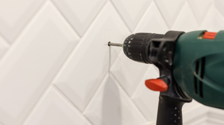 electric drill in bathroom tile 