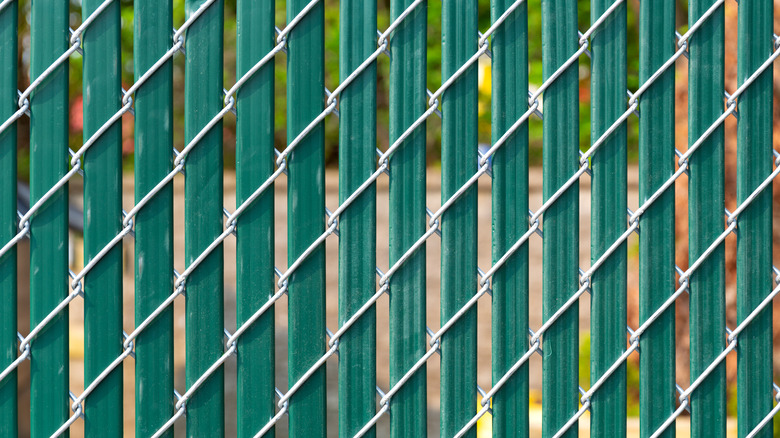 Fence with green privacy slats