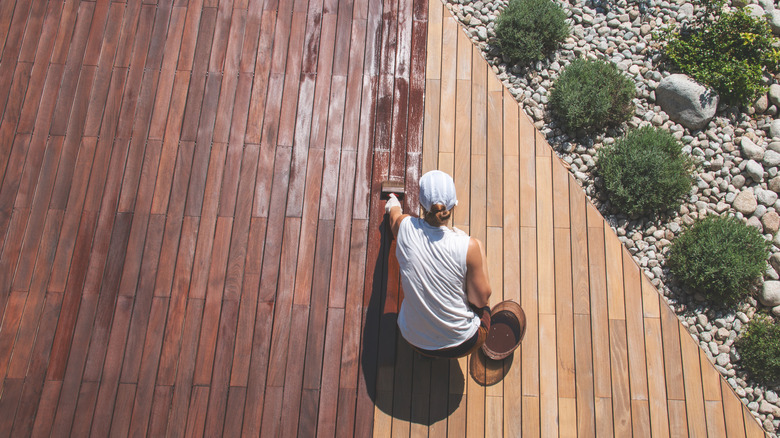 Woman sealing her deck