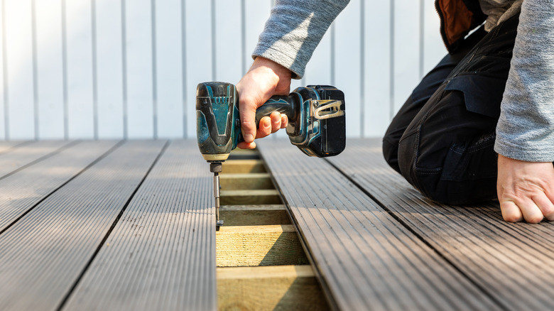 person installing deck boards