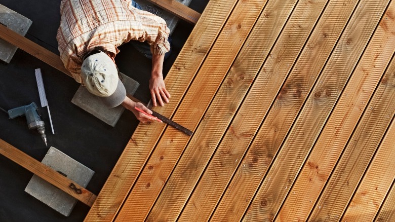 Carpenter installing a wooden deck