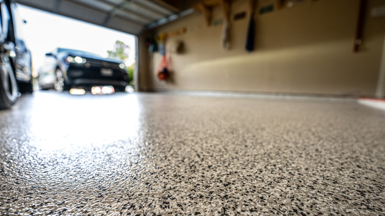 Garage floor and car driving into space