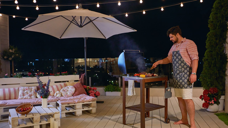 man grilling barbeque on patio