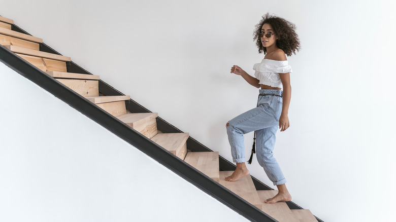 young woman going upstairs