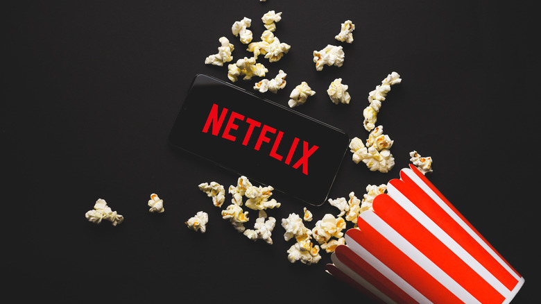 popcorn and Netflix logo on phone