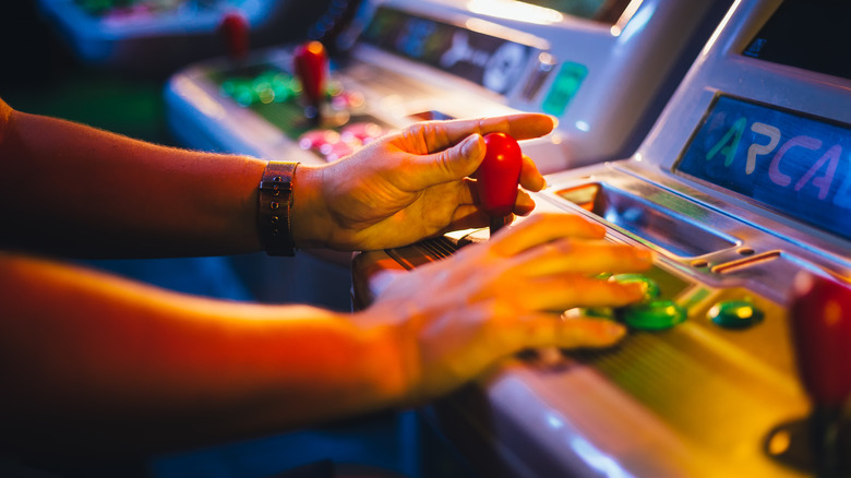 person playing arcade game