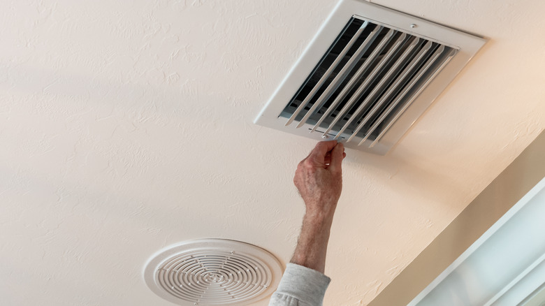 hand opening an air duct