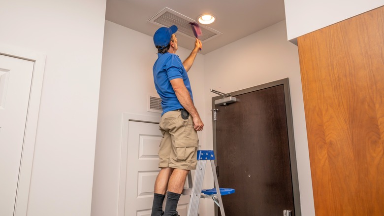 handyman cleaning air duct