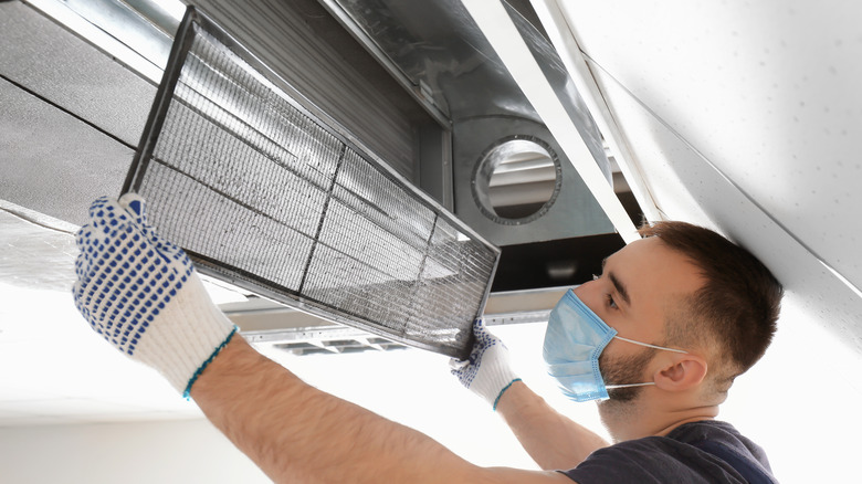 technician cleaning industrial air conditioner
