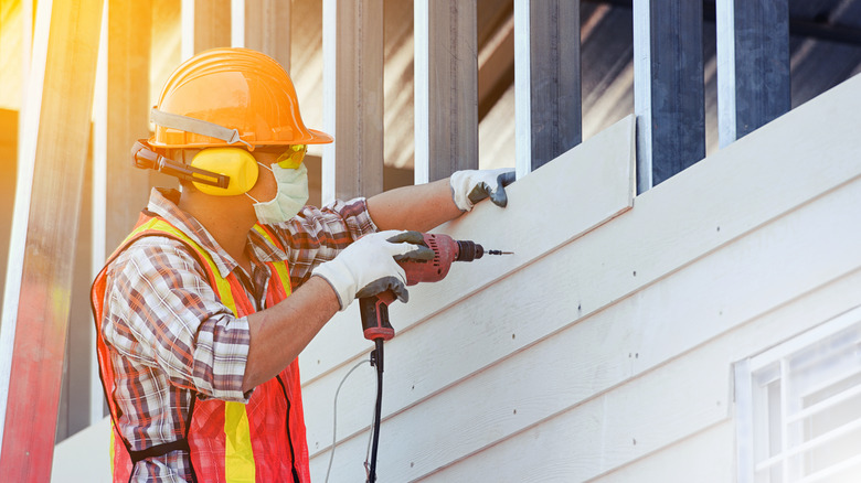 man building part of house