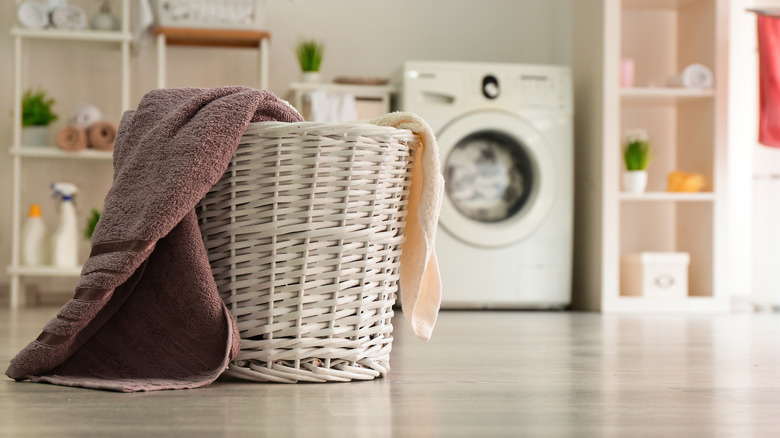 laundry basket in front of front-load washing machine
