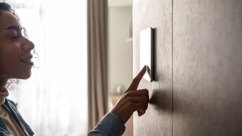 woman operating smart home controls