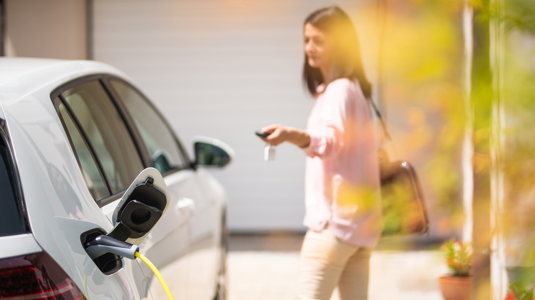 Woman locking electric vehicle