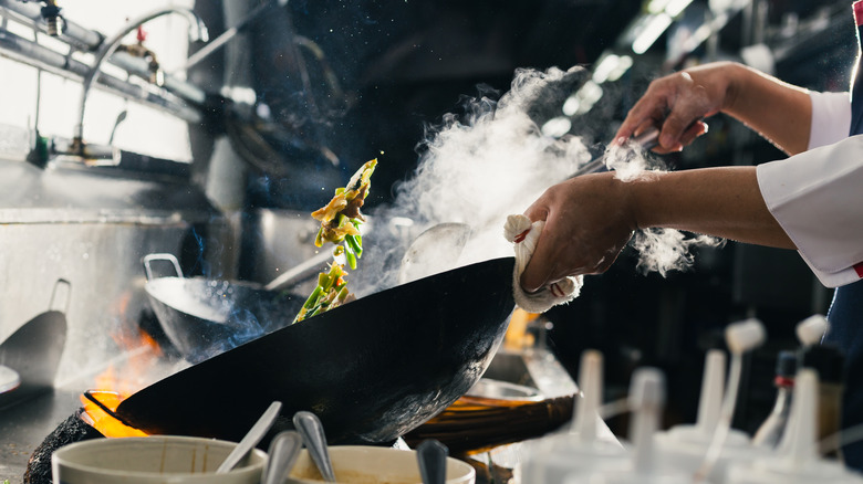 chef cooking on gas stove