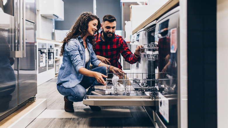 couple shopping for new dishwasher at store