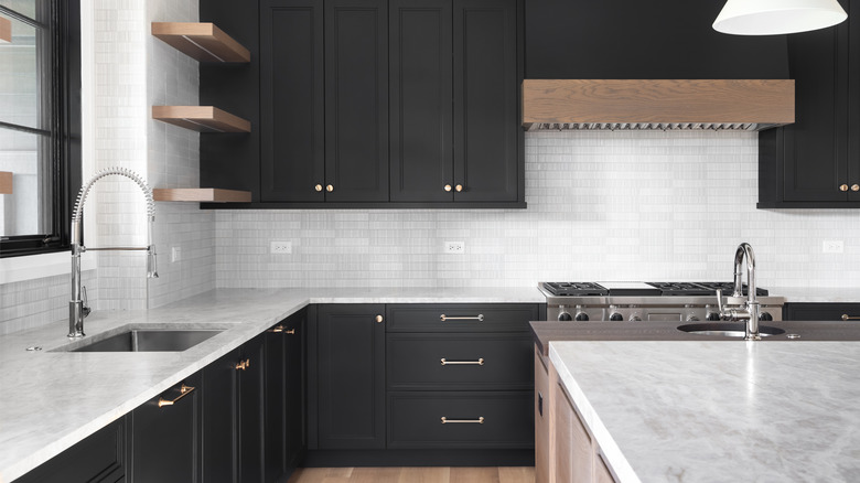 White marble counters with black cabinets