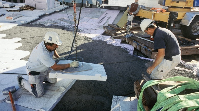 Men cutting marble construction site 