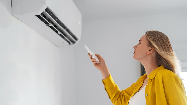 woman with indoor AC unit