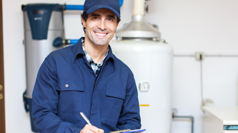 technician servicing hot water heater