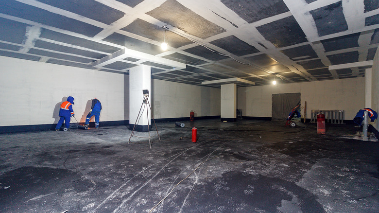 workers waterproofing underground parking