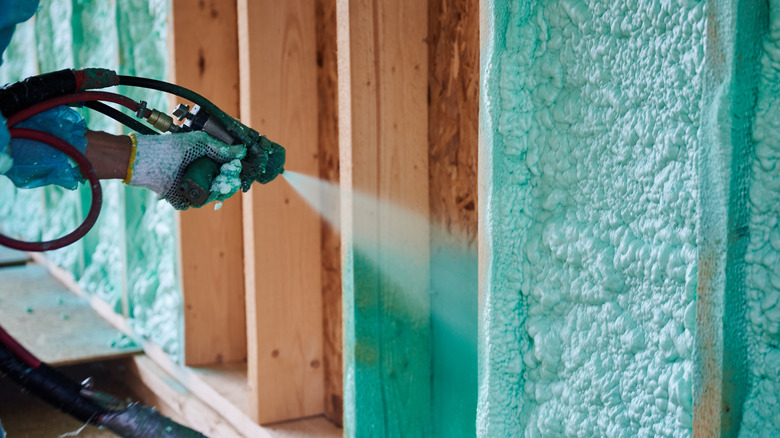 Insulating wood-frame house with spray foam insulation