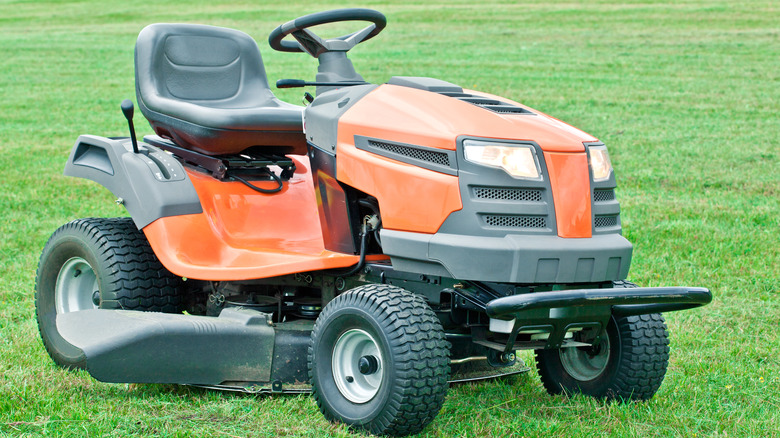 Orange lawn tractor on grass