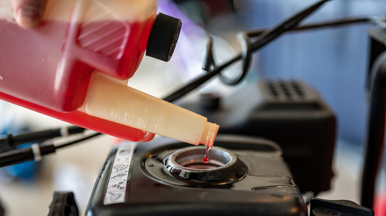 Filling up lawn mower with gas