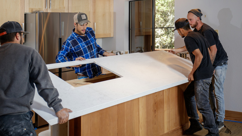 Men installing solid surface countertop