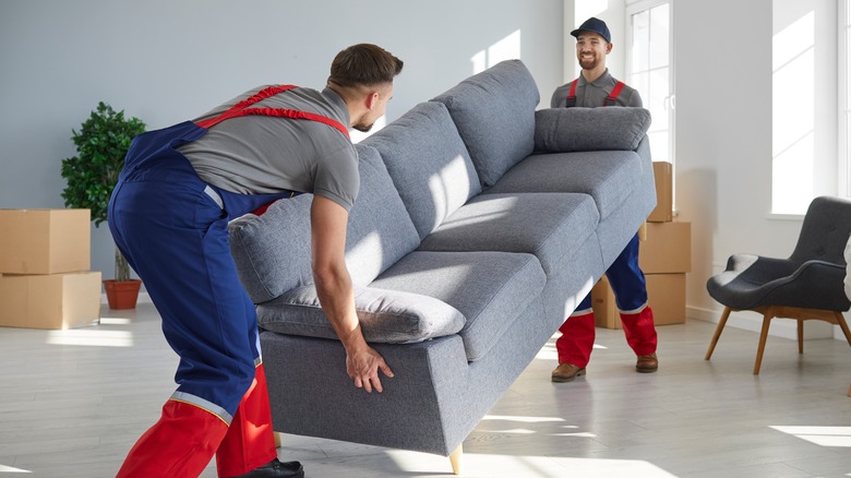 Movers picking up couch