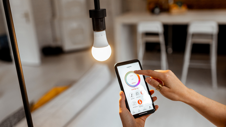 Woman controls light with phone