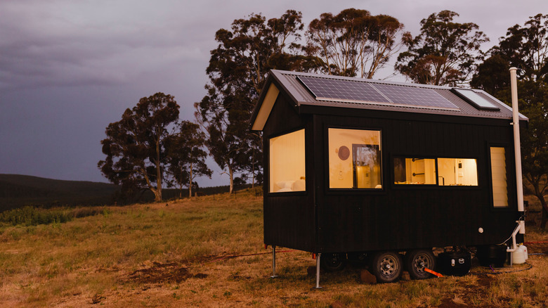 Tiny house in field