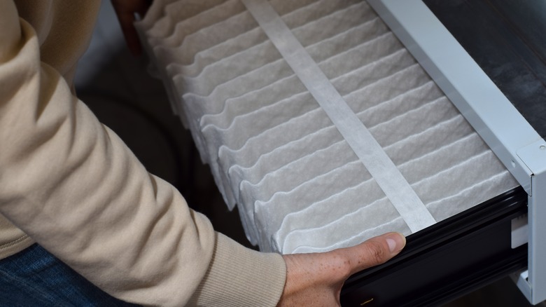 Person replacing air filter