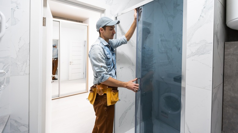 Handyman installing glass door