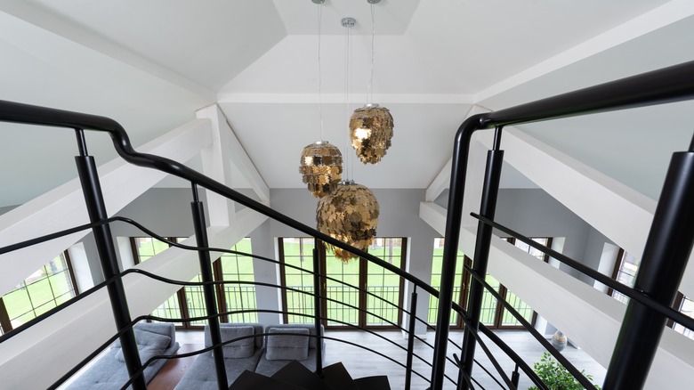 Black metal banister with gold light fixtures