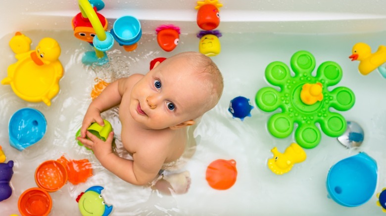 Baby in tub with toys