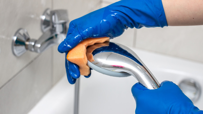 Hands cleaning shower head