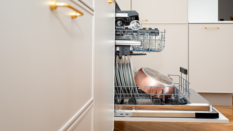 open dishwasher loaded with dishes and pans