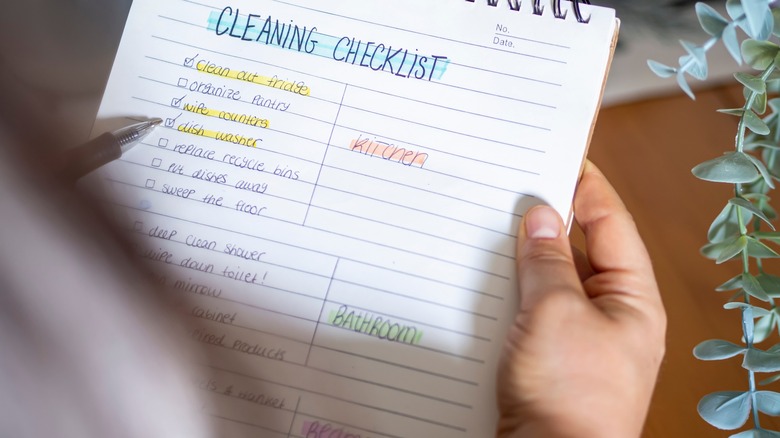 Person holding cleaning checklist