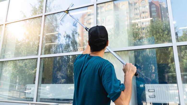 Person cleaning exterior windows