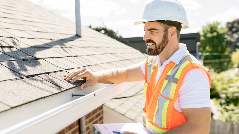 Contractor inspecting gutters 