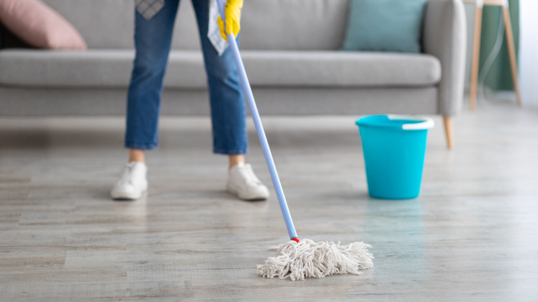 Person cleaning with mop