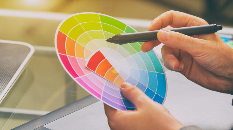 Person holding a color wheel tool