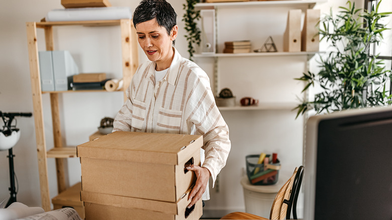 Woman holding cacrbord storage box