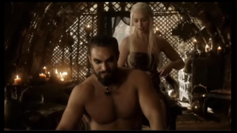 candles surround Khal and Khalessi in tent