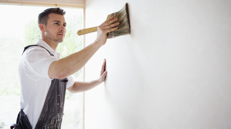 man using paint brush