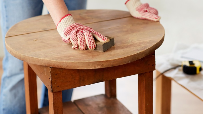 sanding down table manually 