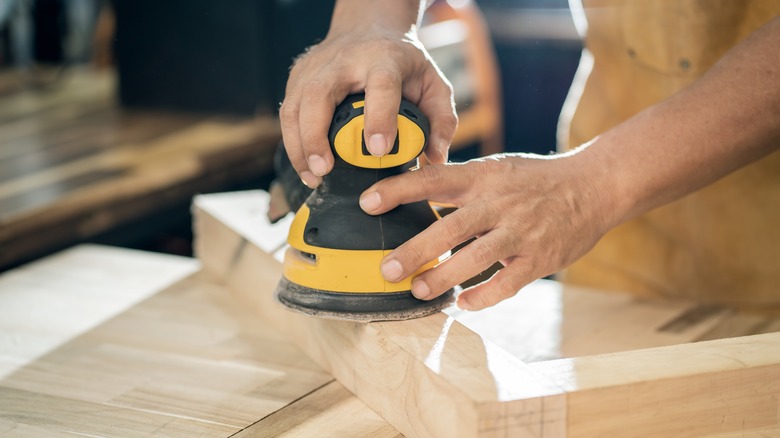 sanding wood with electric sander